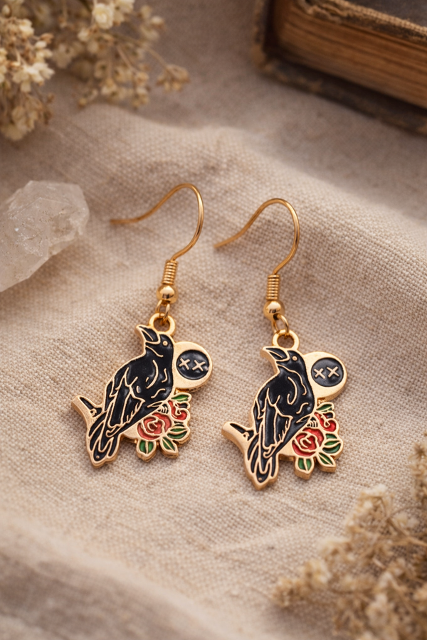 A curated set of Mystic Charm earrings featuring intricate, gothic-inspired designs with enamel detailing and gold-tone hooks. Styled across a mix of clean product shots and moody, aesthetic backgrounds, this collection blends dark elegance with a mystical edge. Each piece showcases unique character and craftsmanship, perfect for adding a bold, alternative statement to any look.