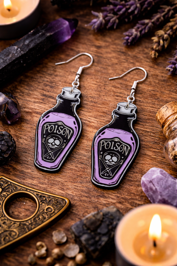 A curated collection of witchy-inspired acrylic earrings featuring dark, mystical designs including celestial symbols, occult figures, crystal shapes, and gothic motifs. Each pair showcases bold black detailing paired with soft lavender accents, displayed in styled scenes with crystals, candles, and moody textures. The collection blends alternative fashion with mystical aesthetics, creating a cohesive, edgy yet feminine visual