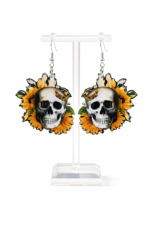 Assorted sunflower-themed acrylic earrings featuring bright yellow petals with dark centers and earthy accents. Each design highlights a rustic, nature-inspired look with bold outlines and clean detailing, displayed on silver fishhook ear wires against a neutral background.