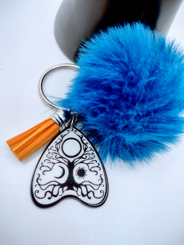Introducing the Spirit Board Style Tree of life keychain. This stylish keychain features a planchette style acrylic key on a chain.