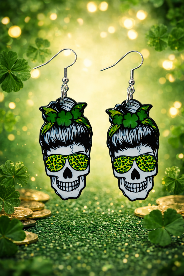 An assorted collection of St. Patrick’s Day-themed acrylic earrings featuring bold, edgy designs with skeletons, skulls, shamrocks, and leprechaun-inspired elements. Each pair showcases vibrant green accents paired with black and white detailing for a high-contrast, gothic-meets-festive aesthetic. Designs include skeleton hands, skull faces, clover details, and playful drinking motifs, all hanging from silver fishhook ear wires. This set blends dark humor, alternative style, and holiday spirit for a unique, statement-making accessory lineup.
