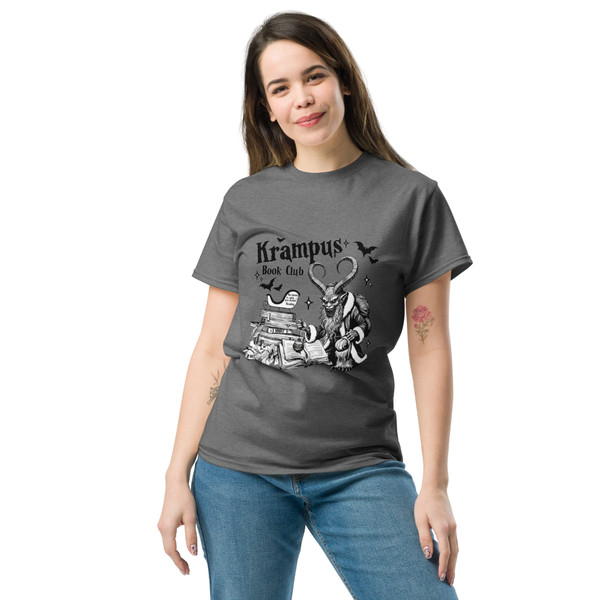 “Book-loving adult holiday tee — Krampus with stack of books”