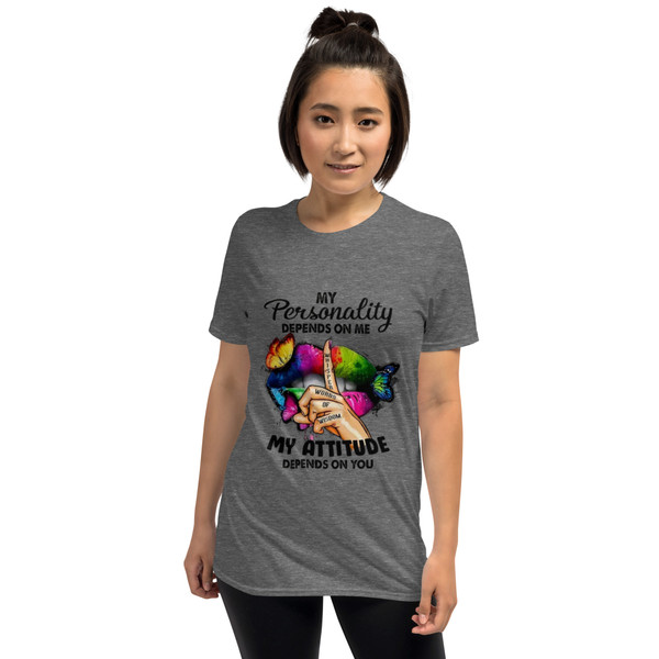 “My Personality Depends On Me My Attitude Depends On You graphic t-shirt featuring colorful neon lips with butterflies and finger whisper design, full view showing vibrant rainbow artwork on light heather gray shirt, perfect for bold inspirational statement wear.”
