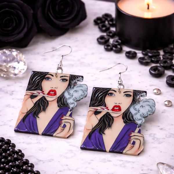 High-quality product images showcasing a pair of bold, gothic-inspired acrylic dangle earrings with a dark, edgy design, captured to highlight detail, size, and overall aesthetic against clean or styled backgrounds.