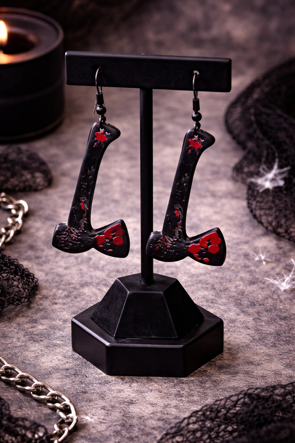 High-quality product images showcasing a pair of bold, gothic-inspired acrylic dangle earrings with a dark, edgy design, captured to highlight detail, size, and overall aesthetic against clean or styled backgrounds.