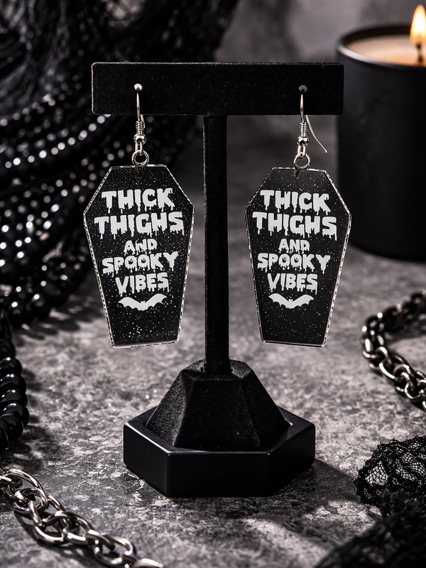 High-quality product images showcasing a pair of bold, gothic-inspired acrylic dangle earrings with a dark, edgy design, captured to highlight detail, size, and overall aesthetic against clean or styled backgrounds.