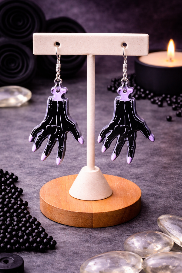 High-quality product images showcasing a pair of bold, gothic-inspired acrylic dangle earrings with a dark, edgy design, captured to highlight detail, size, and overall aesthetic against clean or styled backgrounds.