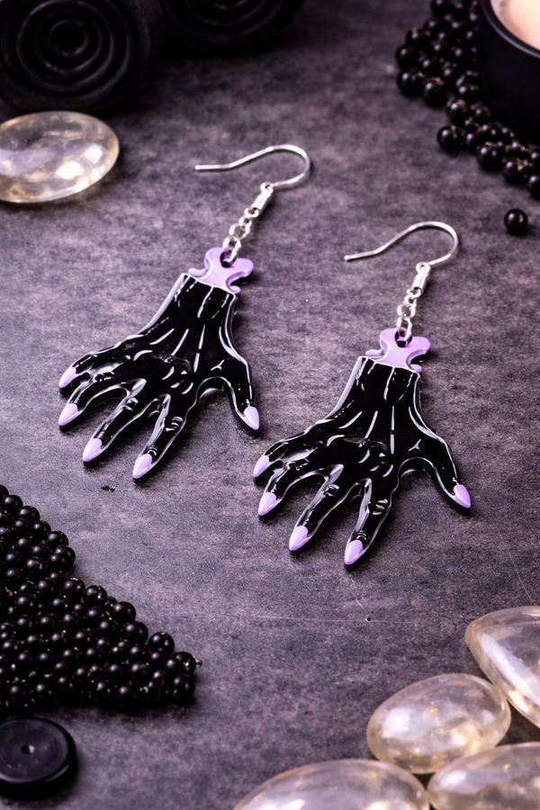 High-quality product images showcasing a pair of bold, gothic-inspired acrylic dangle earrings with a dark, edgy design, captured to highlight detail, size, and overall aesthetic against clean or styled backgrounds.