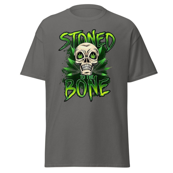 Charcoal gray unisex tee featuring a neon green “Stoned to the Bone” skull design with cannabis leaf eyes and grunge-style lettering, centered on the chest.