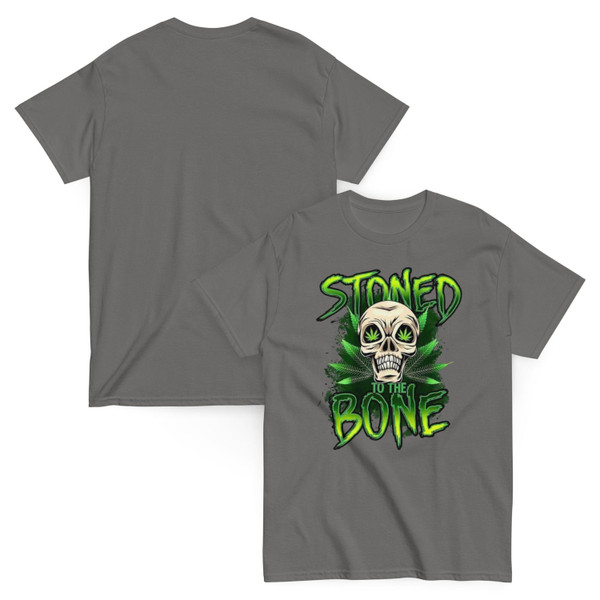 Charcoal gray unisex tee featuring a neon green “Stoned to the Bone” skull design with cannabis leaf eyes and grunge-style lettering, centered on the chest.