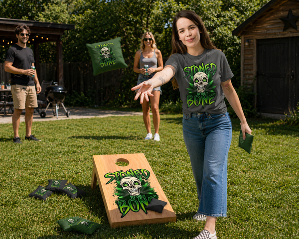 Bring bold attitude to your backyard, tailgate, or party setup. This 3ft tailgate-size cornhole set features our Stoned to the Bone skull design printed on a clean wood grain finish — built for fun, easy transport, and standing out wherever you play.