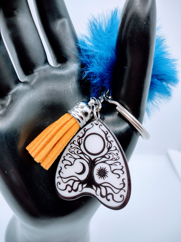 Introducing the Spirit Board Style Tree of life keychain. This stylish keychain features a planchette style acrylic key on a chain.