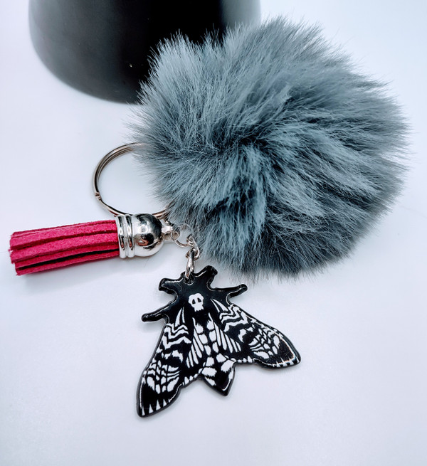 Keychain is the image of the deaths head moth with wings spread ready to fly.