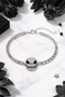 Features a rhinestone skull bracelet showcased across multiple views, including a crisp white background product shot, a clean display stand image for structure and shape, a close-up worn-on-wrist lifestyle photo for scale, and a styled flat lay with dark, gothic-inspired elements to highlight its edgy aesthetic and sparkle.
