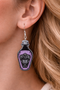 A curated collection of witchy-inspired acrylic earrings featuring dark, mystical designs including celestial symbols, occult figures, crystal shapes, and gothic motifs. Each pair showcases bold black detailing paired with soft lavender accents, displayed in styled scenes with crystals, candles, and moody textures. The collection blends alternative fashion with mystical aesthetics, creating a cohesive, edgy yet feminine visual