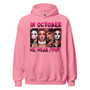 Hoodie featuring Halloween character headshots and the phrase “In October We Wear Pink” in playful pink lettering. Soft, midweight, and cozy with a front pouch pocket and double-lined hood.