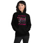 Hoodie featuring full-body illustrations of girls dressed as classic horror movie characters in pink outfits, with the phrase “In October We Wear Pink.” Soft, cozy, and Halloween-ready.