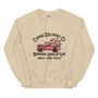 Crew neck sweatshirt in a neutral/pastel color featuring a pickup truck overflowing with red and pink hearts. Text reads “Cupid’s Delivery Co.: Bringing Loads of Love, Smiles, Hugs, and Kisses” in fun, playful lettering. Shown folded and on a flat lay with clear visibility of full design.