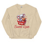 Crew neck sweatshirt shown flat with a cute graphic of a koala sitting inside a cupcake liner. Text reads “Sweet Love” in playful lettering. Pastel, Valentine-inspired colors with a cozy aesthetic.