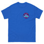Unisex t-shirt displayed flat showing a bright alien graphic printed small on the front pocket and large on the back. Neon-style, colorful design with bold “This Place Sucks” lettering.