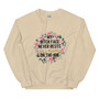 “My Resting Face Never Rests floral wreath crewneck sweatshirt featuring pink flowers and bold statement text on tan sweatshirt, full view showing feminine sarcastic graphic design.”