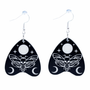 Collection of Ouija planchette acrylic earrings displayed in multiple design variations on a clean background. Each pair features unique lettering styles, symbols, and finishes while maintaining a cohesive dark, witchy aesthetic. The assortment highlights different options within the same occult-inspired theme.