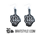 An assortment of edgy acrylic earrings featuring bold, rebellious designs including skeleton hands, sarcastic symbols, and attitude-driven graphics. Each pair showcases high-contrast detailing and expressive themes, styled against clean or minimal backgrounds to highlight their statement-making appeal.