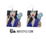 An assortment of edgy acrylic earrings featuring bold, rebellious designs including skeleton hands, sarcastic symbols, and attitude-driven graphics. Each pair showcases high-contrast detailing and expressive themes, styled against clean or minimal backgrounds to highlight their statement-making appeal.