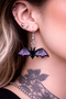 High-quality product images showcasing a pair of bold, gothic-inspired acrylic dangle earrings with a dark, edgy design, captured to highlight detail, size, and overall aesthetic against clean or styled backgrounds.