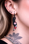 High-quality product images showcasing a pair of bold, gothic-inspired acrylic dangle earrings with a dark, edgy design, captured to highlight detail, size, and overall aesthetic against clean or styled backgrounds.