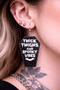 High-quality product images showcasing a pair of bold, gothic-inspired acrylic dangle earrings with a dark, edgy design, captured to highlight detail, size, and overall aesthetic against clean or styled backgrounds.