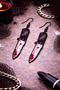High-quality product images showcasing a pair of bold, gothic-inspired acrylic dangle earrings with a dark, edgy design, captured to highlight detail, size, and overall aesthetic against clean or styled backgrounds.