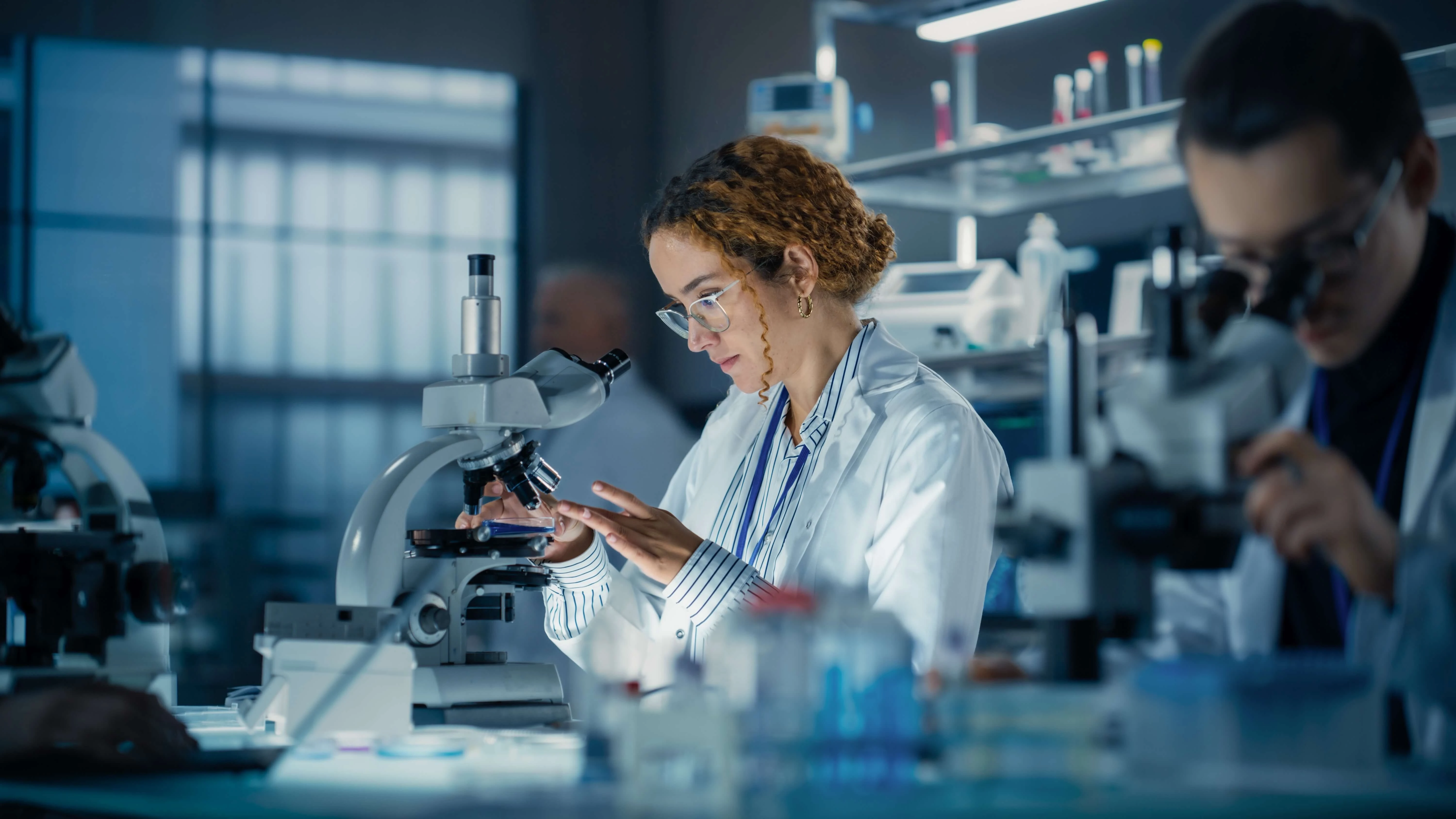 Doctor looking in microscope