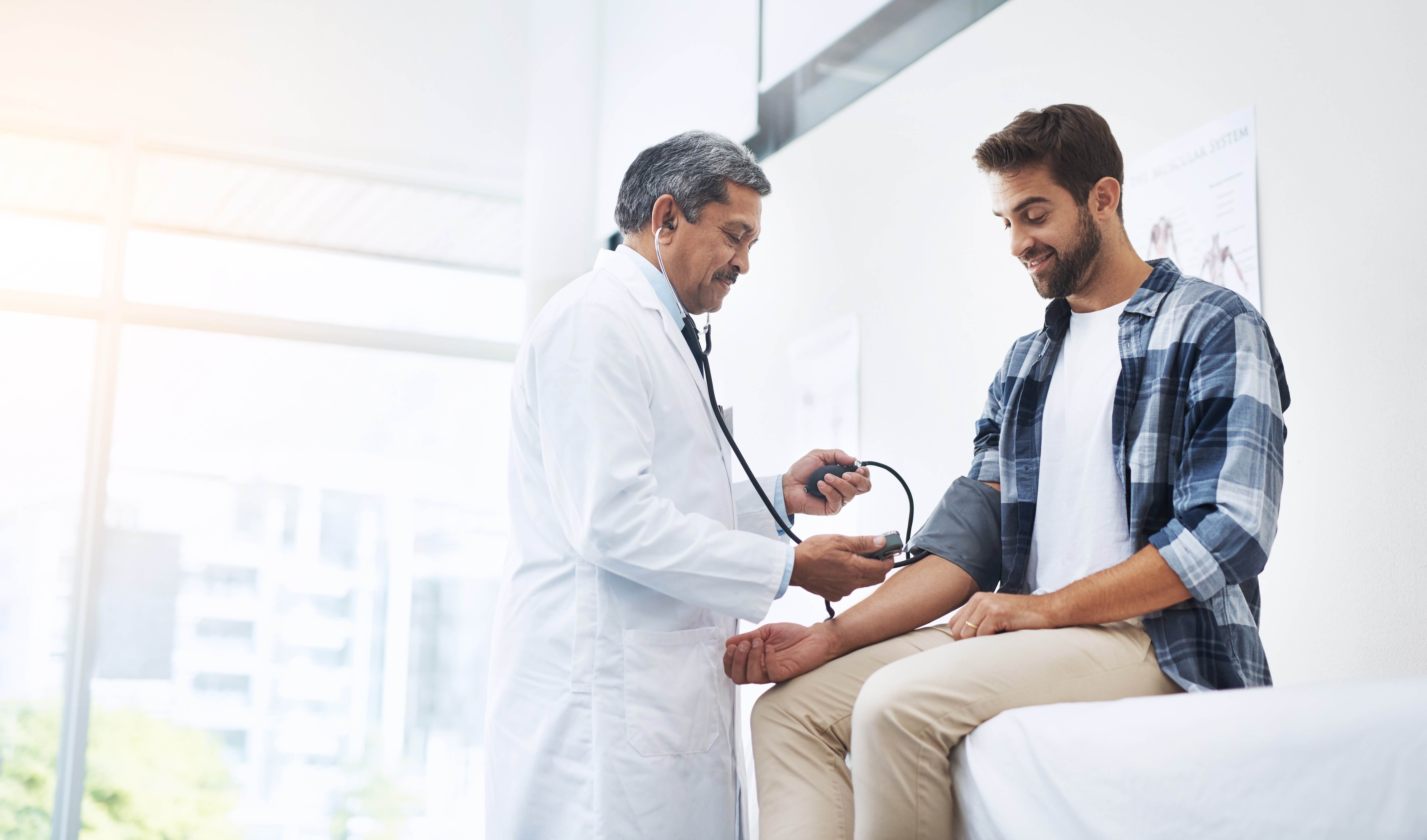 Doctor checking patient's blood pressure