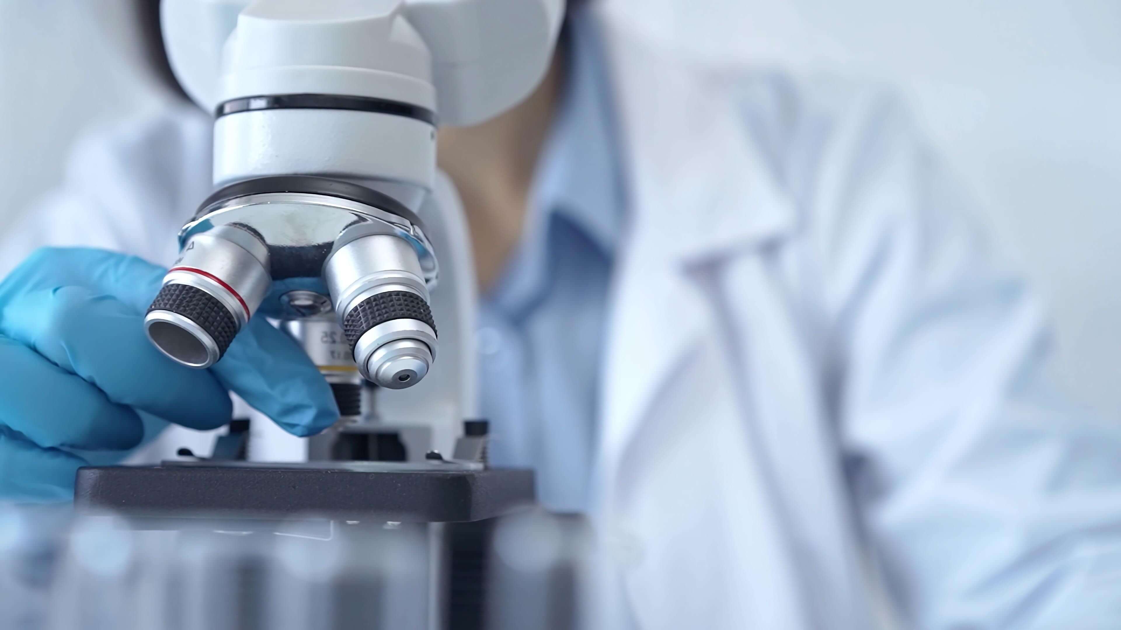 Doctor looking into a microscope