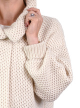 Close-up of collar and cuff of a woman wearing a Cymone baby alpaca cardigan