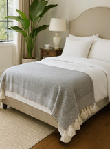 Cloud9 Tassel Frame Reversible Premium Baby Alpaca Throw Blanket - on bed in bedroom. Cloud9 Tassel Frame Reversible Premium Baby Alpaca Throw Blanket - on bed in bedroom.