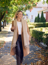 Sustainable Organic Alpaca Houndstooth Scarf on model with coat outside. Sustainable Organic Alpaca Houndstooth Scarf on model with coat outside.