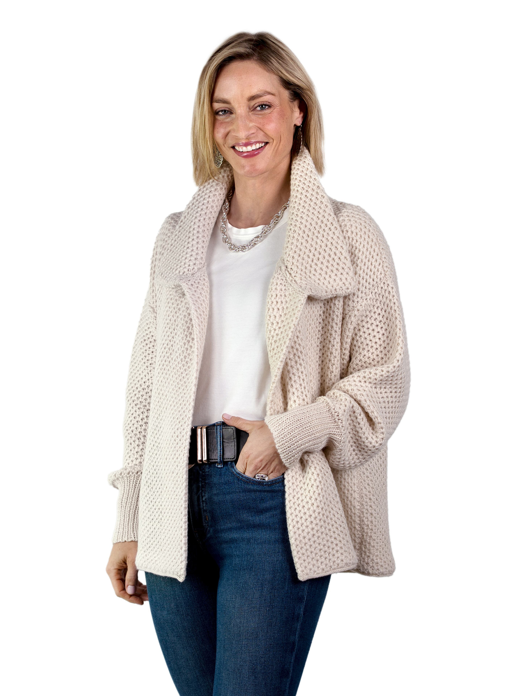 Woman wearing a Cymone baby alpaca cardigan in natural ivory. Main image.