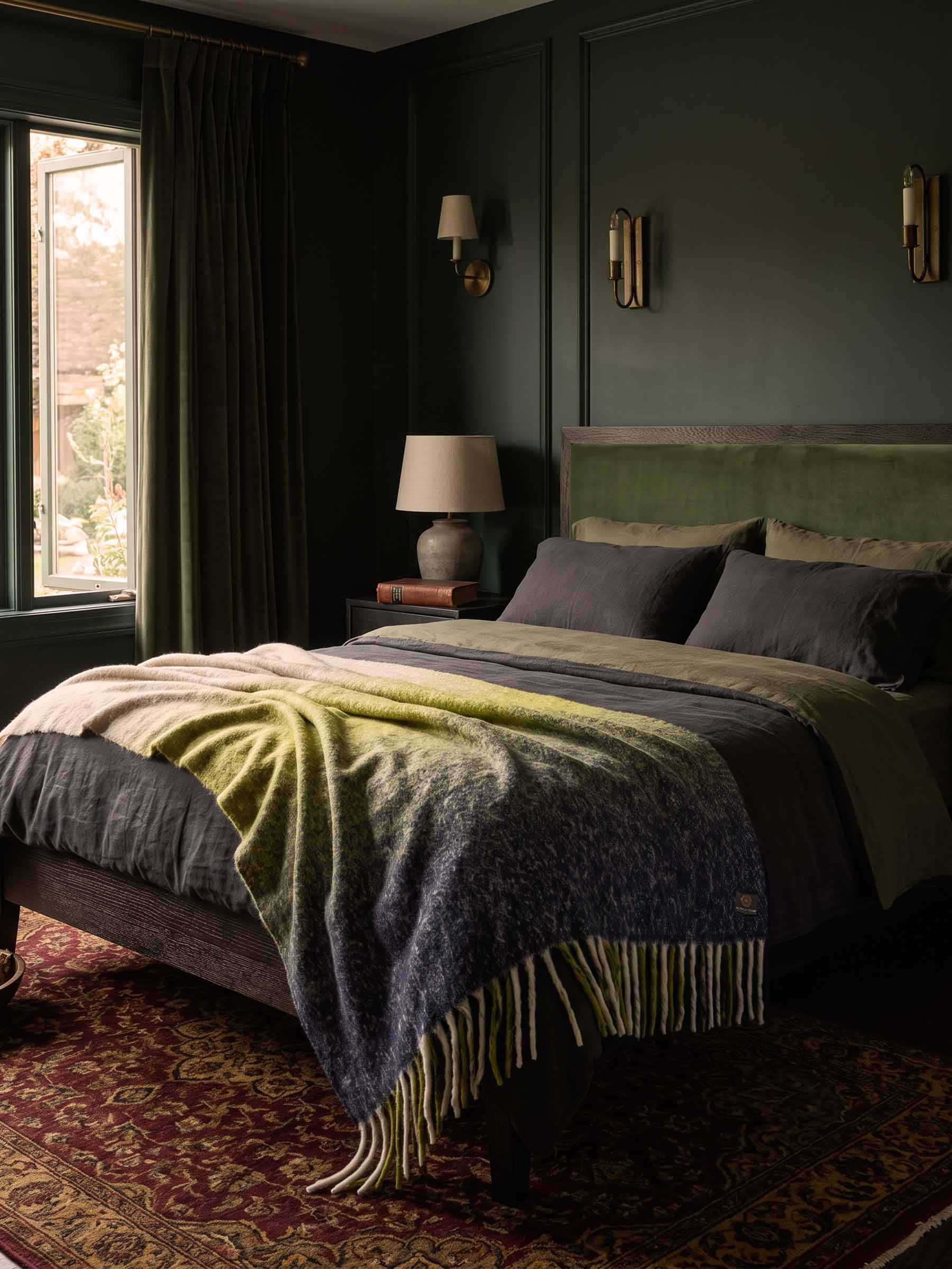 The Horizon Ombré Bouclé Alpaca Throw in Emberlight on bed in bedroom