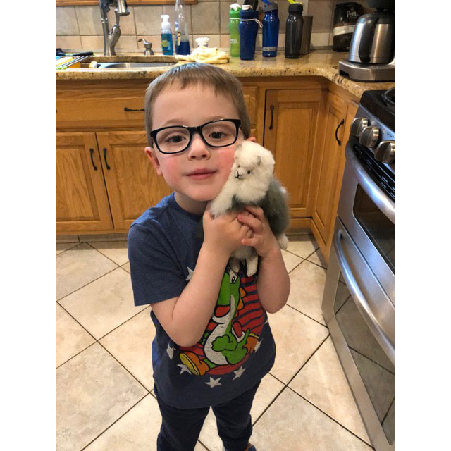Satisfied Alpaca Customer holding 9" Alpaca Fur Stuffed Animal
