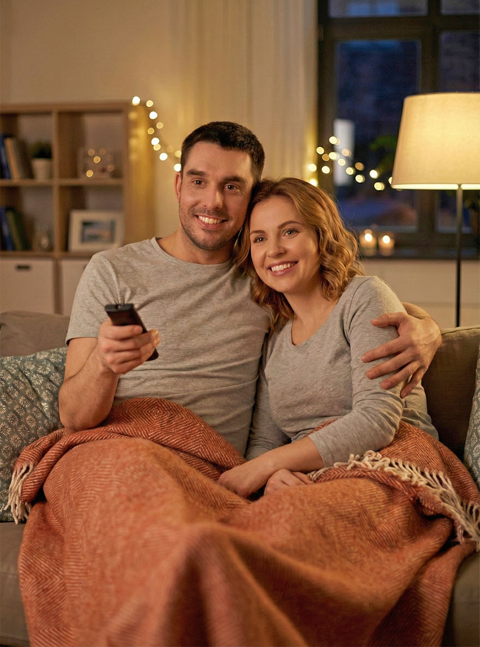 Alpaca Home Monopoly Baby Alpaca Throw Blanket on couple watching TV.
