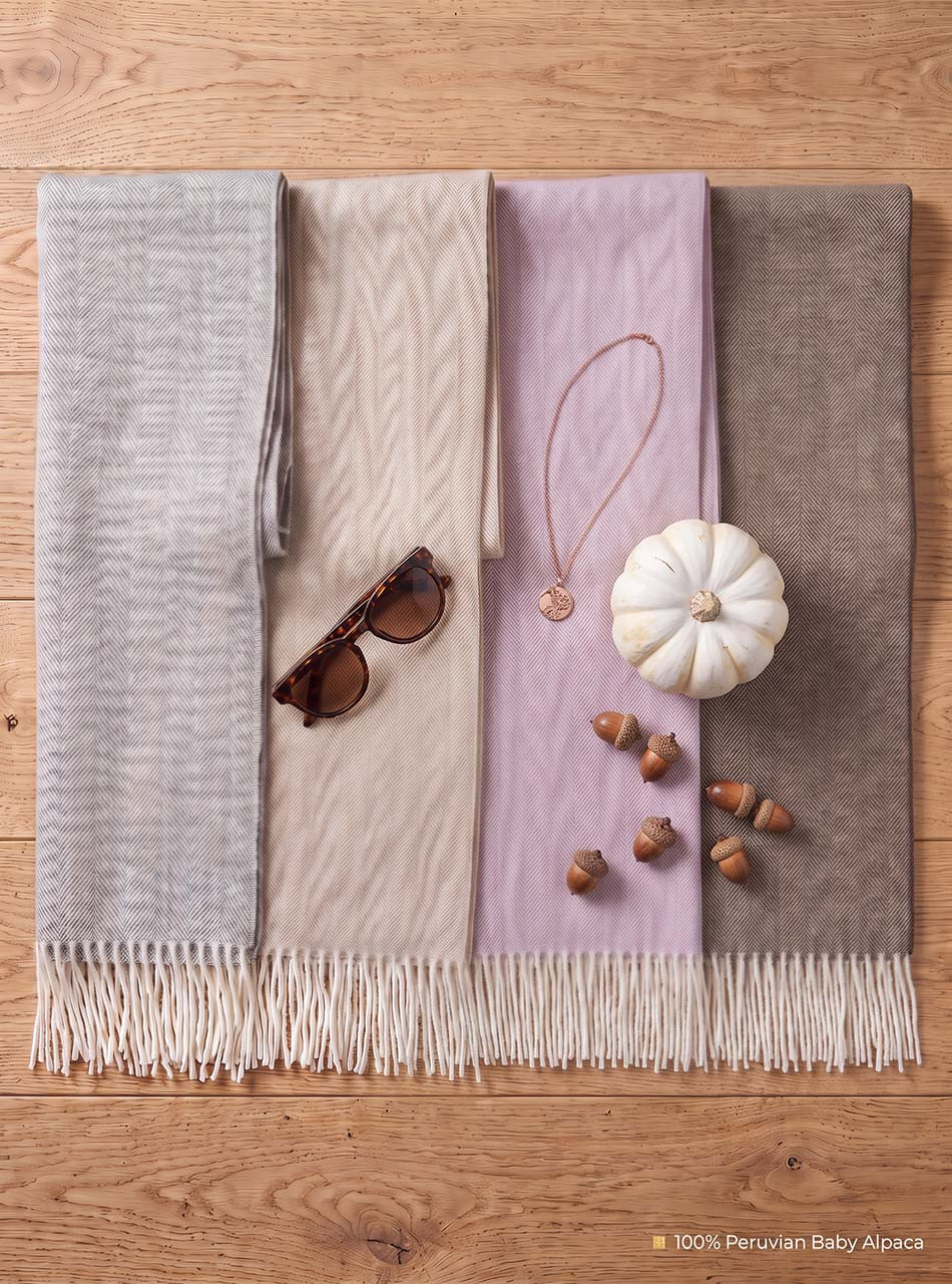Herringbone Scarf Flatlay featuring four scarves and seasonal items