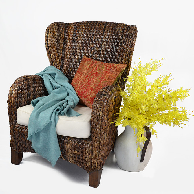 Liam Alpaca Throw Blanket on Traditional Rattan Chair