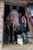 Rider wearing green Highland Cow riding socks beside a horse and dog at the stable.