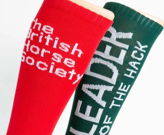 Close-up of personalised wording knitted into red and green sock bands