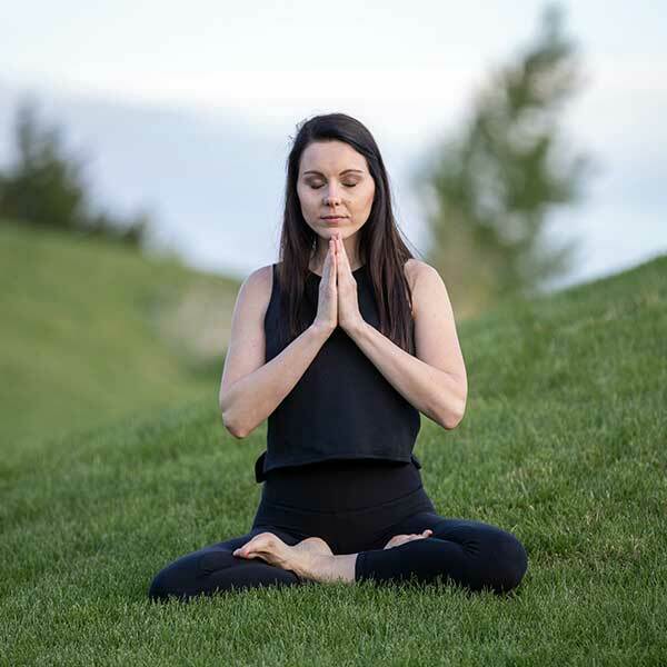 Woman Sat on Grass Going Yoga