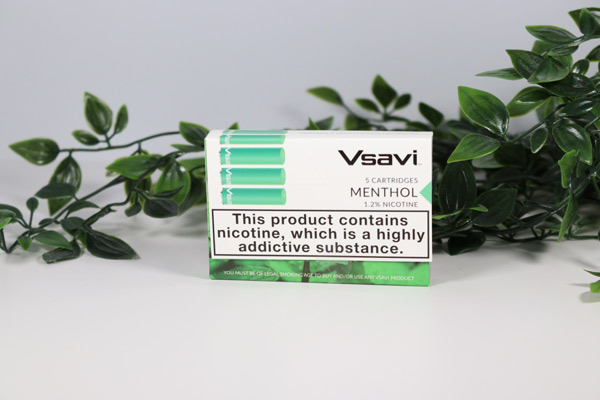 Vsavi menthol cartridges Lifestyle image of Vsavi menthol cartridge pack of five surround by leaves on a white background.