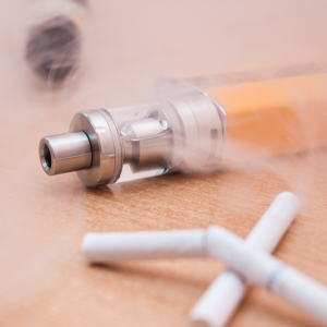 broken menthol cigarettes next to a vape pen broken menthol cigarettes next to a vape pen