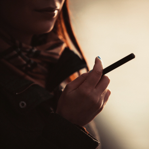 girl smoking a e-cigarette from a starter kit